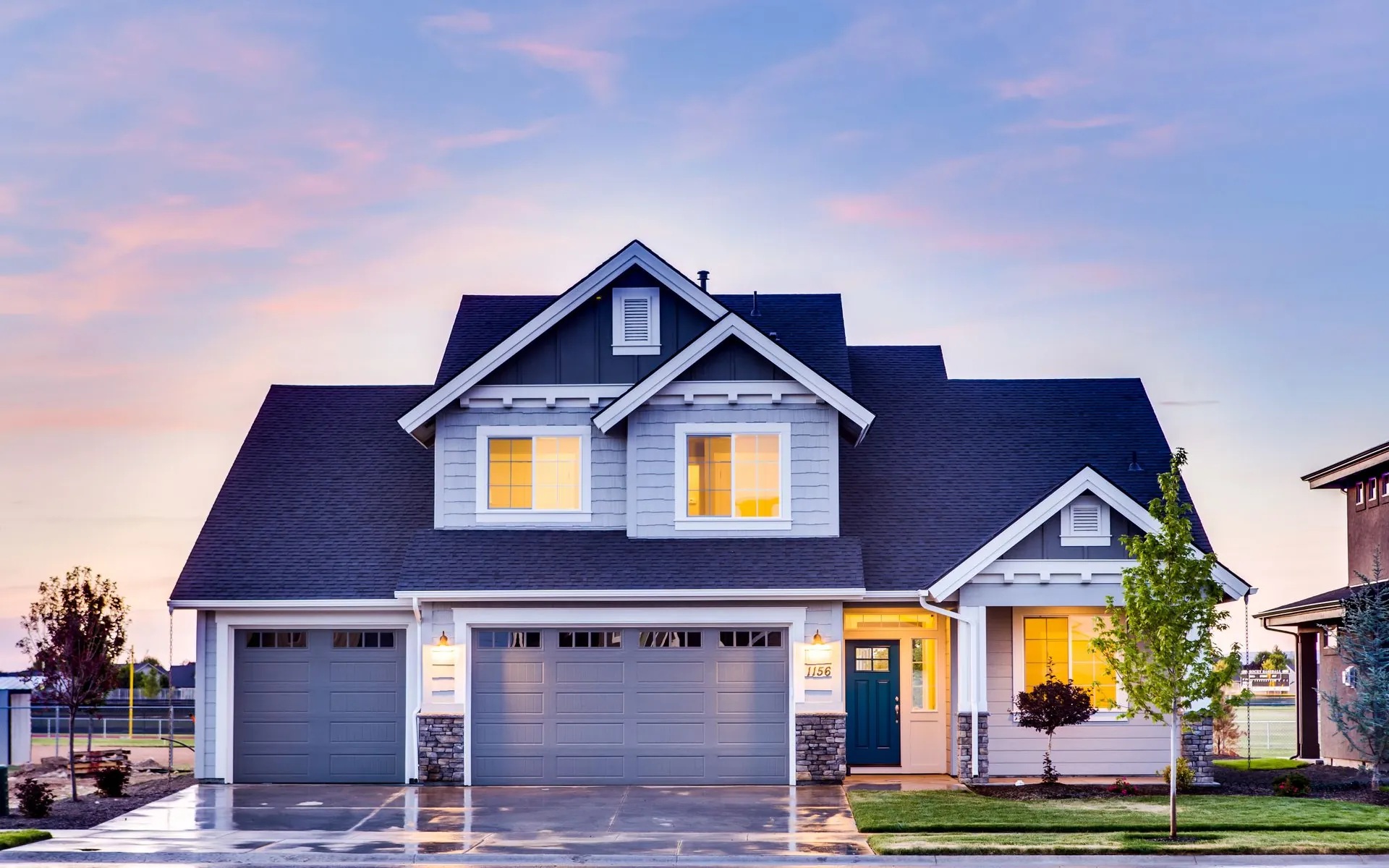 Puget Sound craftsman home at dusk with warm interior lighting after a completed HVAC installation